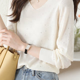 V-neck knitted sweater with hot-fixed rhinestones.