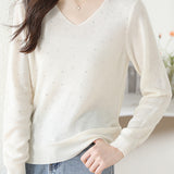 V-neck knitted sweater with hot-fixed rhinestones.