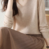 V-neck knitted sweater with hot-fixed rhinestones.