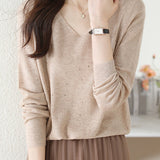 V-neck knitted sweater with hot-fixed rhinestones.
