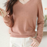 V-neck knitted sweater with hot-fixed rhinestones.