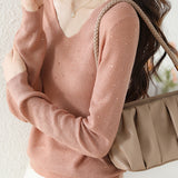V-neck knitted sweater with hot-fixed rhinestones.