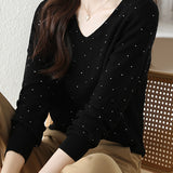 V-neck knitted sweater with hot-fixed rhinestones.
