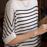 Versatile loose-fit striped short-sleeve knit top.