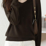 V-neck knitted sweater with hot-fixed rhinestones.